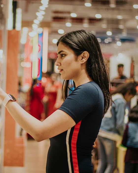 A woman browsing beauty products on a store shelf