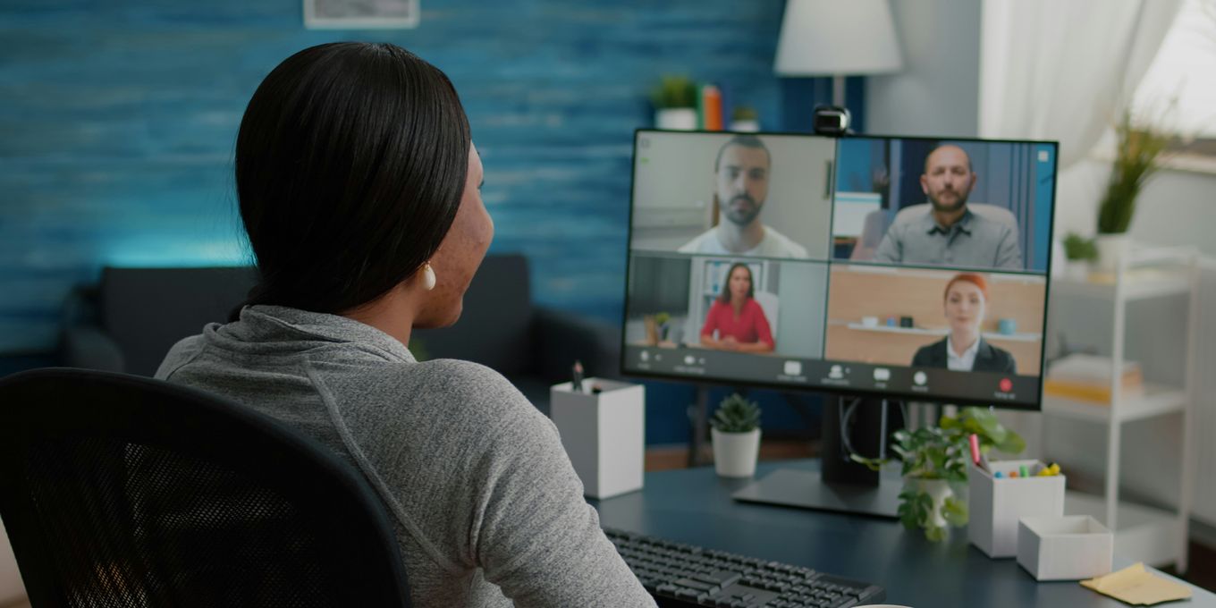 A marketer on a video call with four colleagues in different offices
