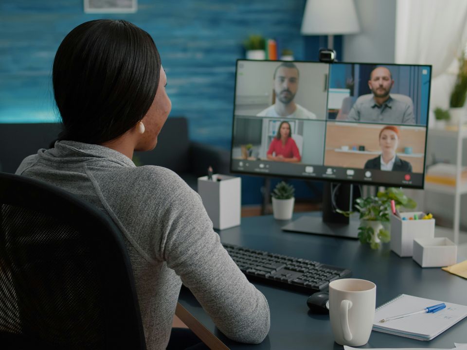 A marketer on a video call with four colleagues in different offices
