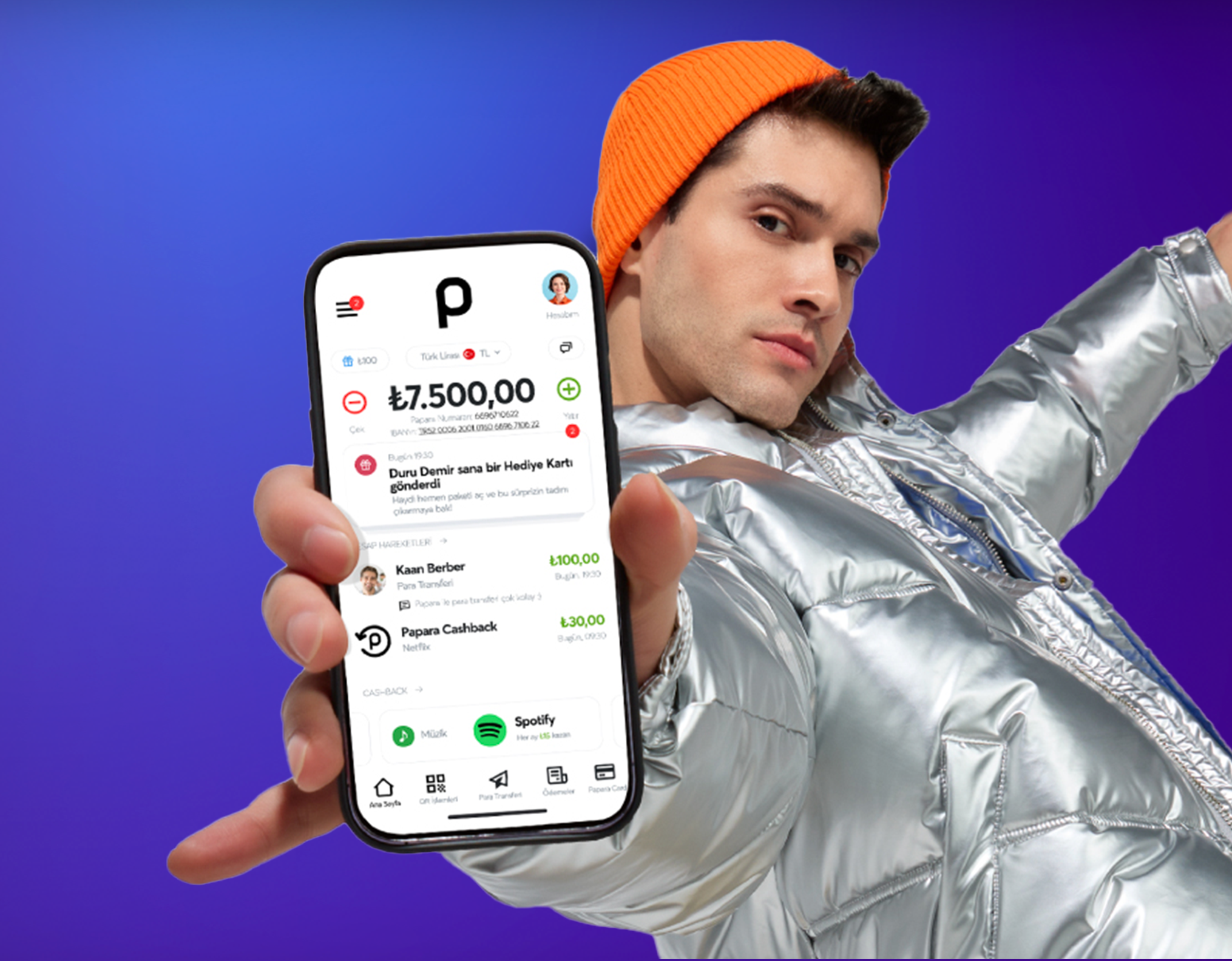 A Young Man holding a phone with Papara App on the screen