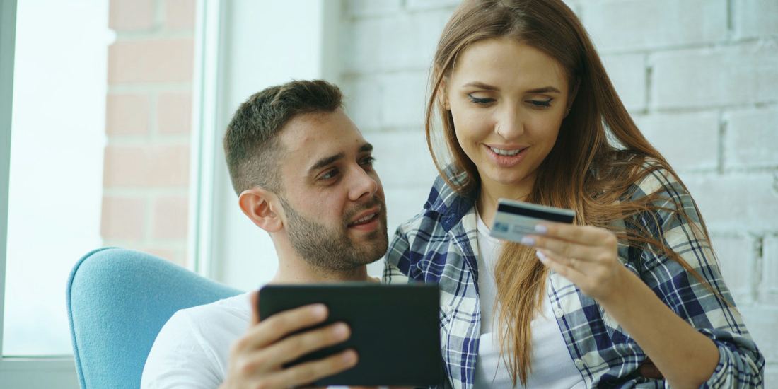 Two people shopping online together on a tablet